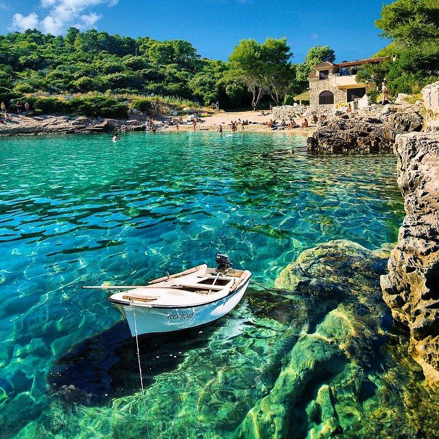 Boat resting on the clear, turquoise waters of Korčula