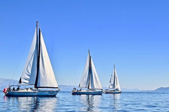 Three sailboats out at sea 