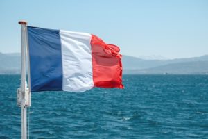 French flag on the back of a sailboat