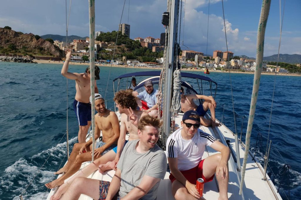 Boys sailing of Coast in Barcelona.