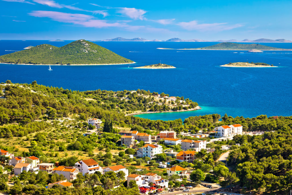 Aerial view of the Bay of Opat in Croatia surrounding with islands, boats and buildings 