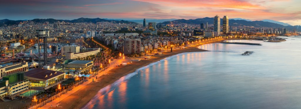 An evening aerial view of the coastline of Barcelona at the ending port of this Barcelona itinerary