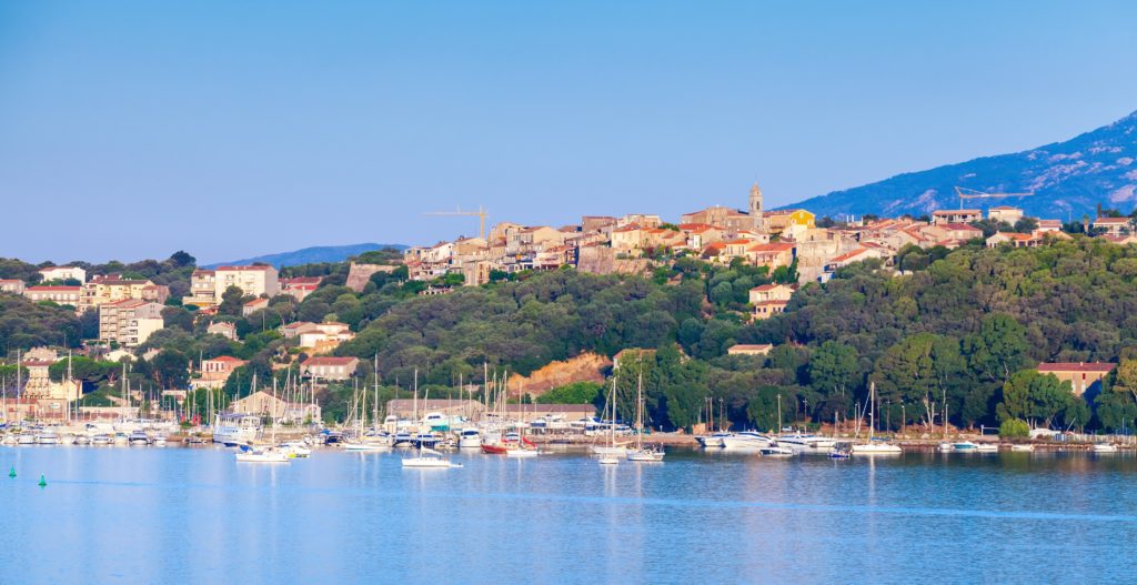 View of the port in Porto Vecchio with the surrounding city and greenery