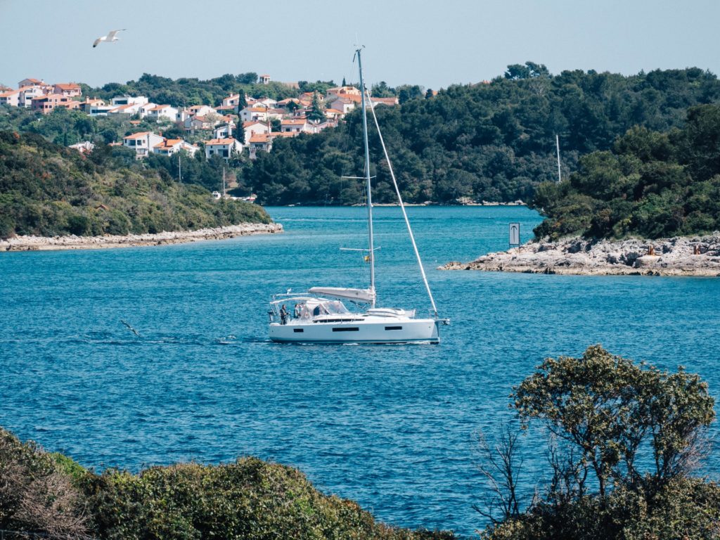 View of a sailboat showing the seaside town in the background