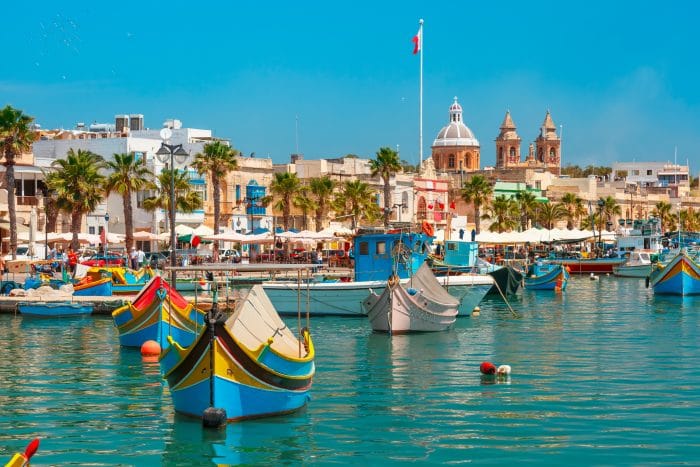 View of the anchoring colourful boats in the port in Marsaxlokk