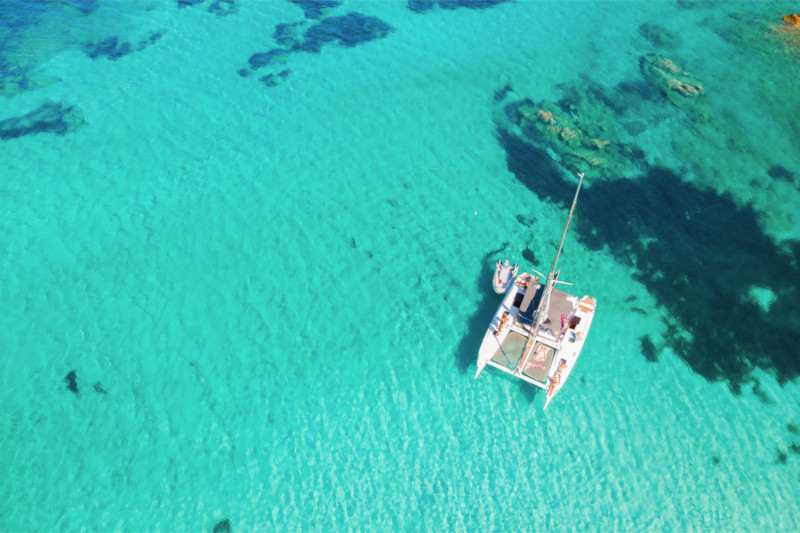 Catamaran anchored in clear turquoise water