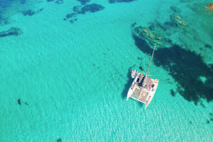 Catamaran anchored in clear turquoise water