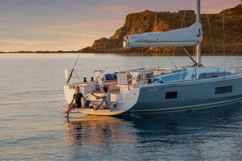 Couple enjoying time aboard a catamaran anchored in a quiet bay