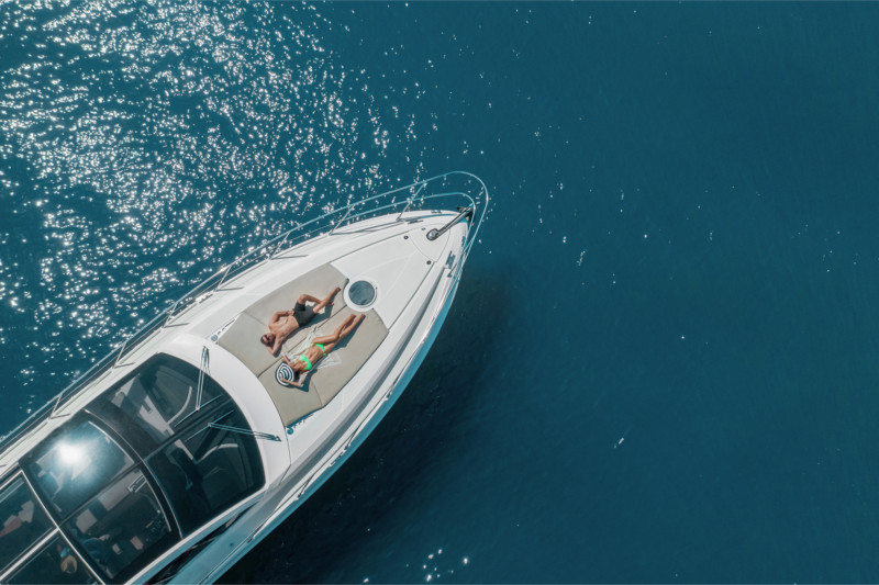 Travelers relaxing aboard a boat anchored in calm waters